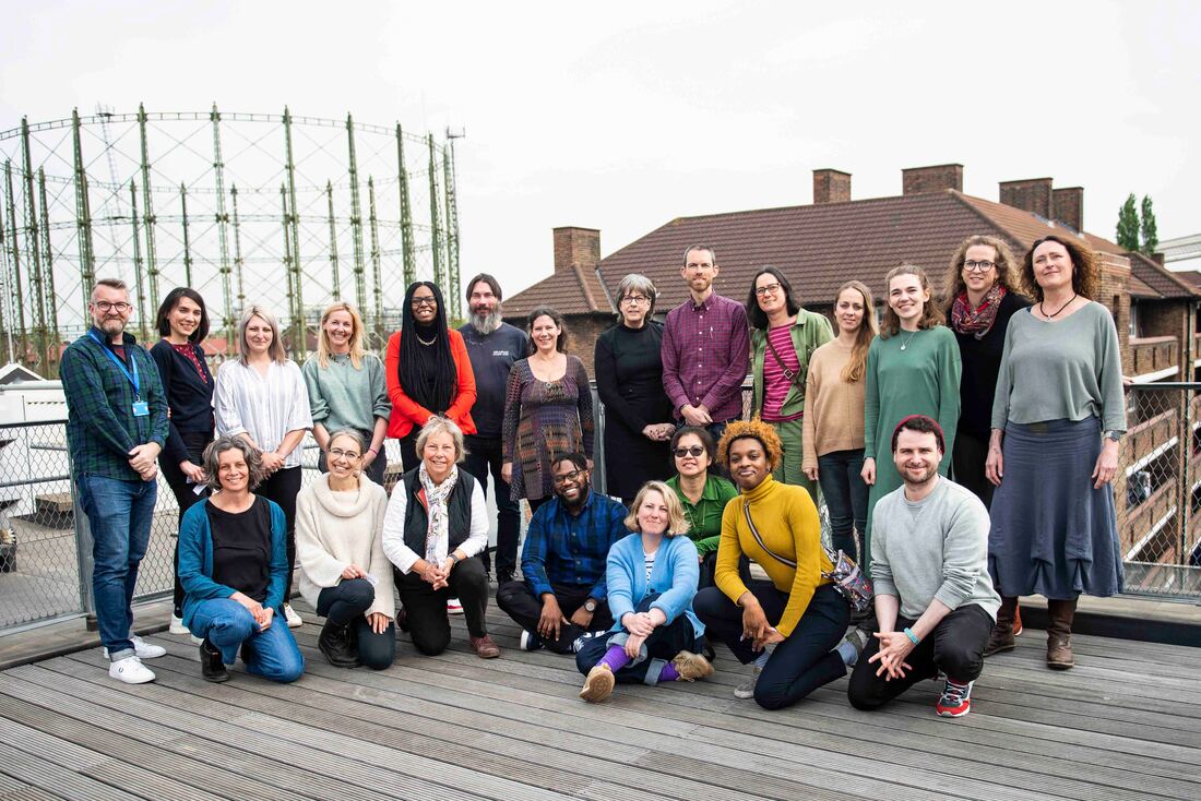 Clean Slate and Quids in! staff stand together on a rooftop in East London